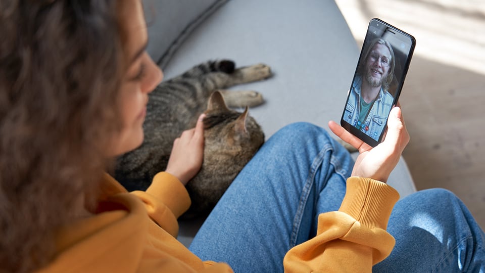 woman video calling with phone to get paid as a virtual friend