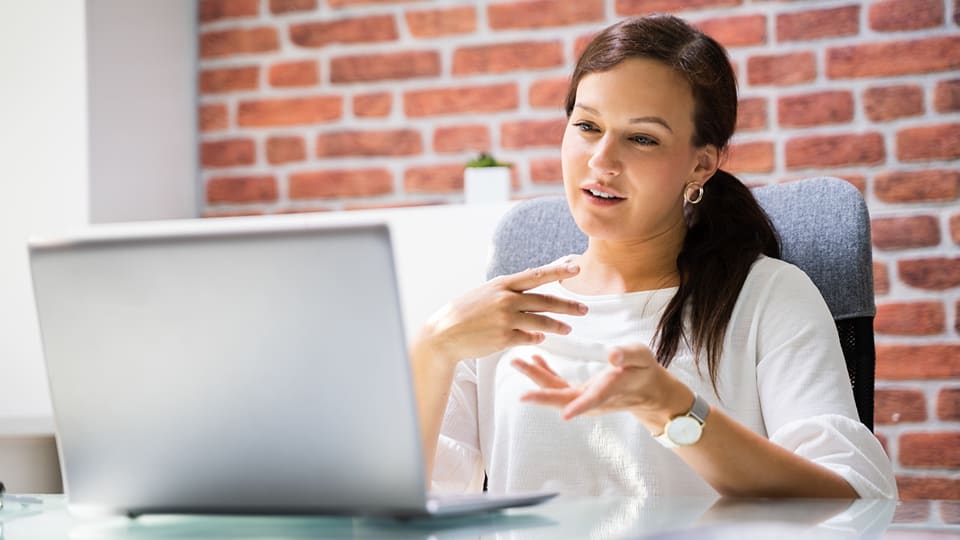 woman using laptop to get paid as a virtual friend